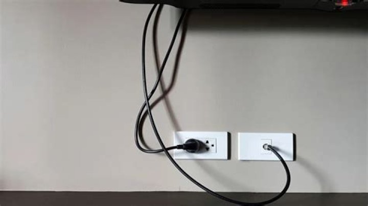 Can I run a power cord behind a wall?